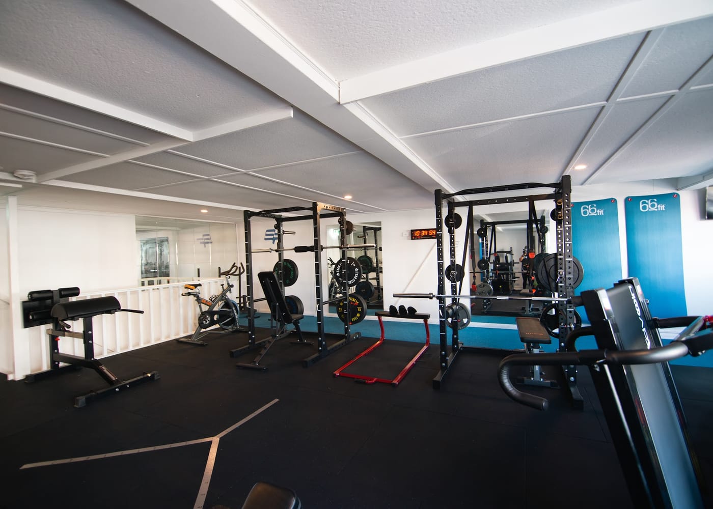 The performance gym at SportsFit Five Dock: squat racks, benches and the blue turf runway
